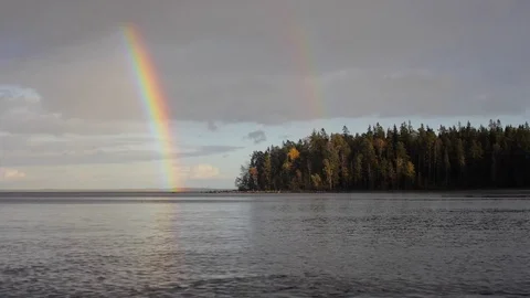 Northern nature landscape of lake and forest with double rainbow Stock Footage
