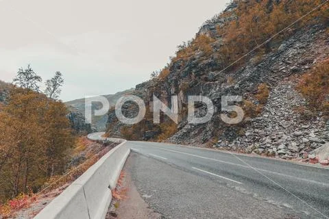 Northern Norway, road in a big ravine on an early autumn day on the road betw Stock Photos