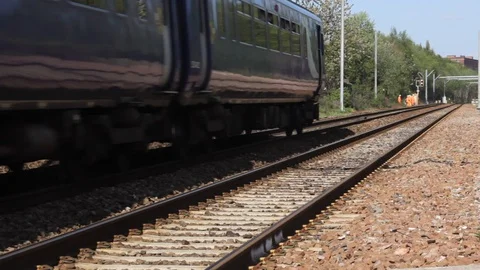 Northern Rail train passing a trackside engineering team in Hi-Vis clothing. Stock Footage 87619444