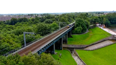 Northern western train passing through carr mill dam, St Helens Stock Footage 160471602