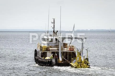 Northstar Commander towing Axys WindSentinel wind monitoring system into Buzz Stock Photos