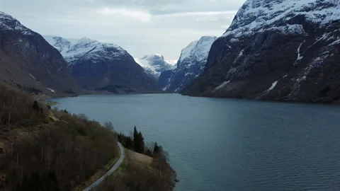 Norway Mountain Valley Aerial Pull Back with Winding Road Stock Footage 336584376