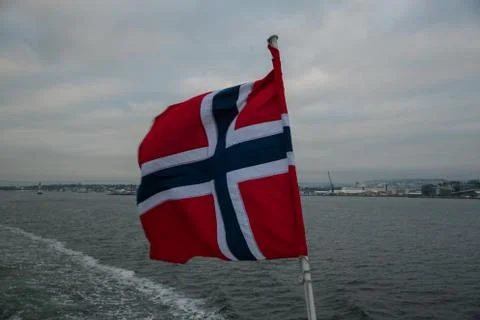 Norway's floating flag captured by wind at sea during sailing. 库存照片
