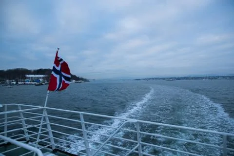 Norway's floating flag captured by wind at sea during sailing. Photos