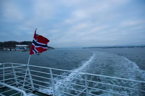 Norway's floating flag captured by wind at sea during sailing. Foto stock