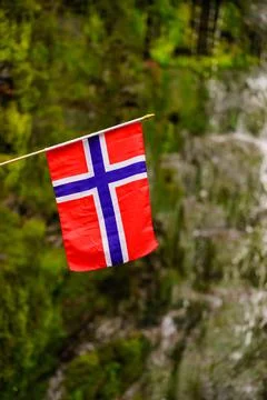 Norwegia flag and waterfall in mountains Stock Photos