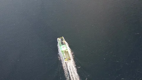 Norwegian car ferry navigating the dark blue waters of a fjord Video stock 335198506