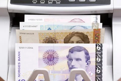 Norwegian crown in the counting machine Stock Photos