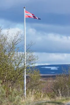 Norwegian flag in flagpole with wind Stock Photos