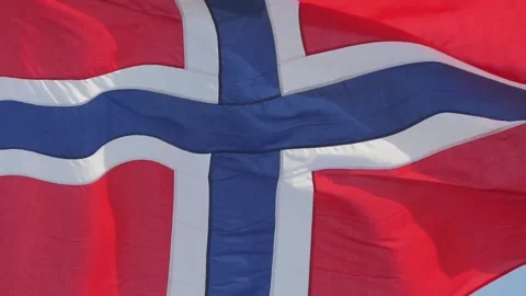 The Norwegian flag waving in the wind in slow motion against a blue sky. Stock Footage 152533993