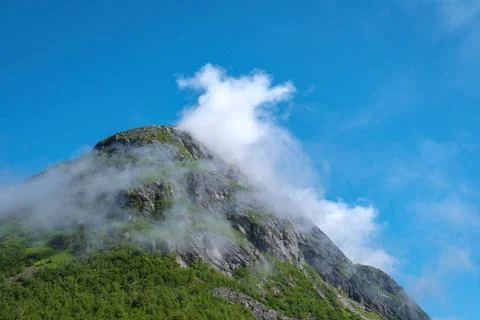 Norwegian Mountain Peak Enveloped in Mist A mountain peak in Norway is shr... Stock Photos