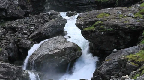 Norwegian mountain waterfall medium shot pull to long shot Stock Footage 27520062
