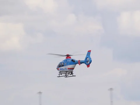 Norwegian police politi helicopter passing by rear view slow motion Stock Footage