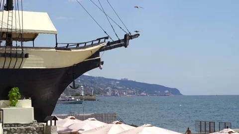 The nose of the old ship against the backdrop of the sea lighthouse and a Stock Footage 113456746