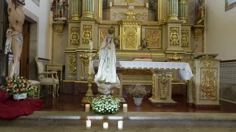 Nossa Senhora de Fátima Statue and Flowers Before Gilded Altar in Church Stock Footage 343707448