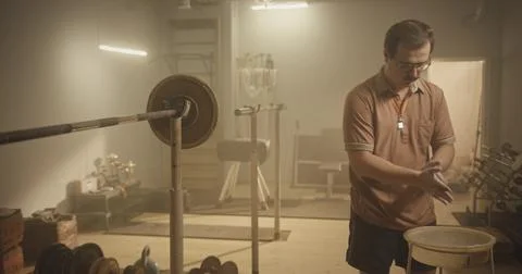 Nostalgic Attempt: Coach Faces Challenges in a Retro Gym Stock Photos