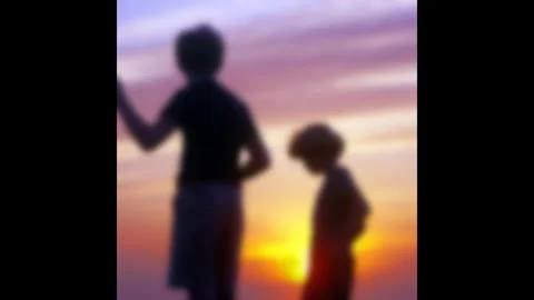 Nostalgic Blurred Silhouette of Children Playing and Throwing Stones into Water Stock Footage 322746294
