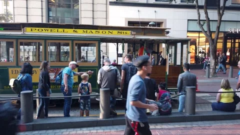 Nostalgic cable car arriving into station with people waiting in queue Stock Footage 258789911