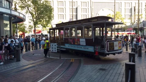 Nostalgic cable car arriving into station while tourists waiting in queue Stock Footage 258790756