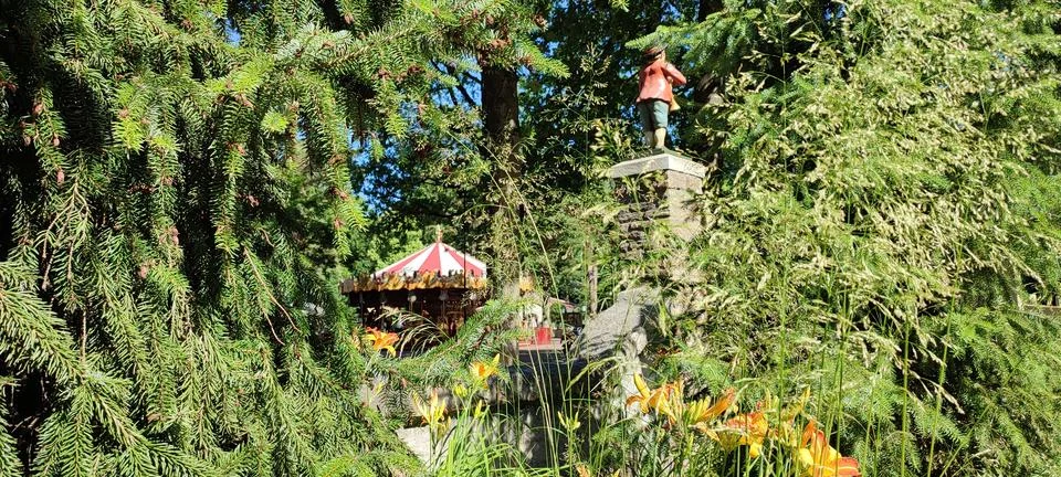 Nostalgic Carousel seen through Forest Stock Photos