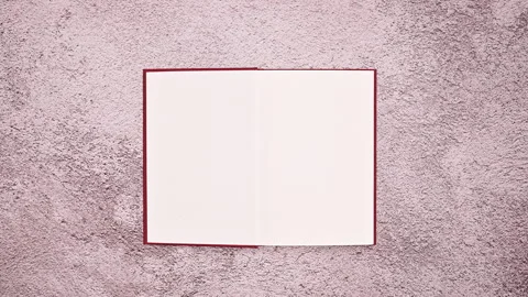 Nostalgic Charm: Woman's Hand Opens Retro Hardcover Book Video stock 254813887