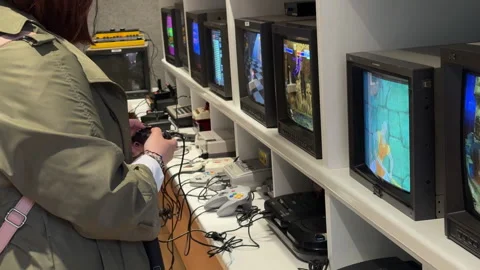 Nostalgic classic CRT televisions displaying fun vintage video games. Stock Footage 313292918
