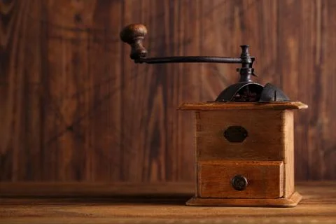 Nostalgic coffee grinder on old table Stock Photos