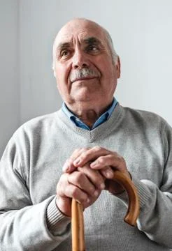 Nostalgic elderly man with a walking cane or stick Stock Photos
