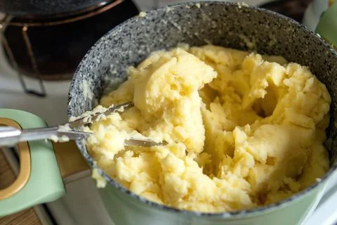Nostalgic kitchen scene featuring a pot of creamy mashed potatoes, accompan.. Stock Photos