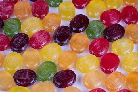 Nostalgic multicolored candy pattern evoking childhood memories, glossy surfa Stock Photos