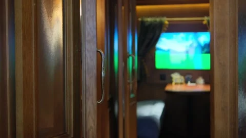 A nostalgic train compartment featuring wooden doors, a cozy bed, a small table Video stock 302498091