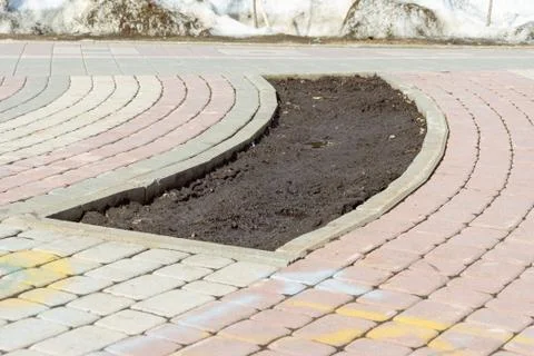 Not planted empty flowerbed in the form of a sector of the ring surrounded by Stock Photos