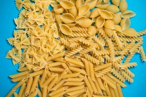 Not prepared a dry paste of different species on a blue background in various Stock Photos