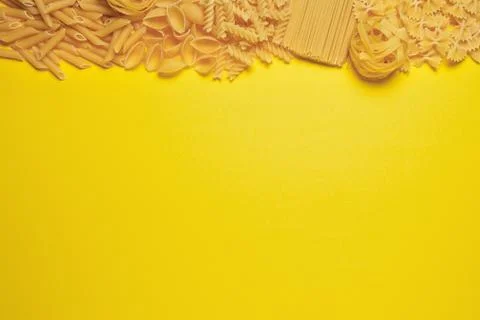 Not prepared a dry paste of different species on a yellow background in vario Stock Photos