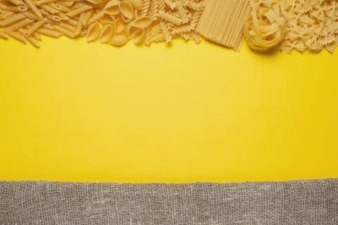 Not prepared a dry paste of different species on a yellow background in vario Stock Photos