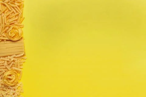 Not prepared a dry paste of different species on a yellow background in vario Stock Photos