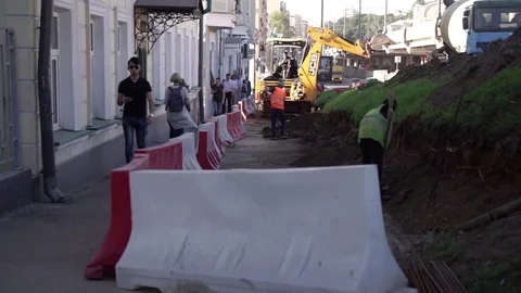 /not Relevant - Apr 24 2016: People people bypass building. Road Repairs. rRed Stock Footage 78999464