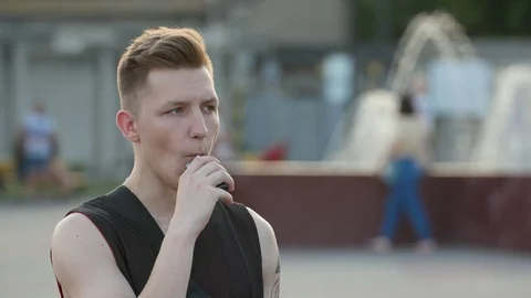 Not satisfied young stylish man with blond hair tasting (smoking) electronic 库存影片 112140146