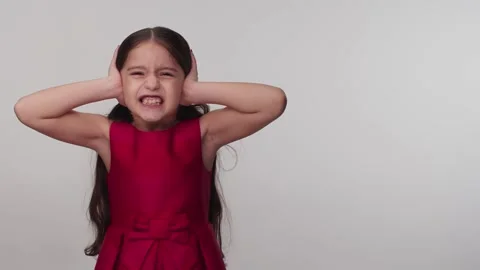 Not wanting to hear the evils, the little girl covers her ears and screams. Stock Footage 147012208