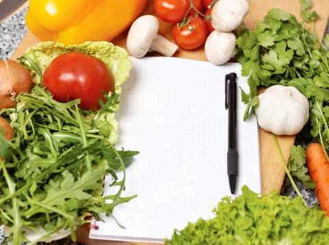 Note book among the vegetables Stock Photos