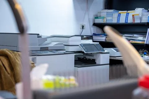 Note Book Binding Machine  with printers in the background Stock Photos