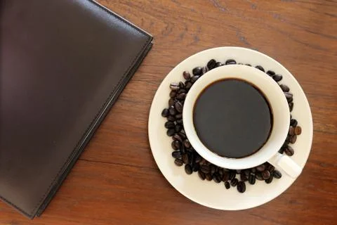 Note book with coffee cup Stock Photos