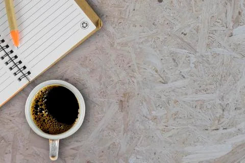 Note book with coffee cup Stock Photos