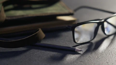 Note book with leather covering, glasses and pencil, artists kit, stylish pic Stock Footage 154789276