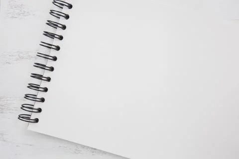 Note book on white table Stock Photos