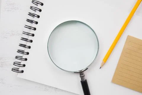 Note book on white table with yellow pencil Stock Photos