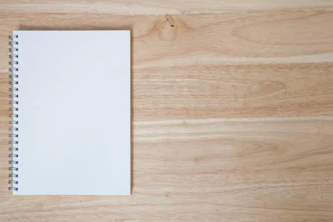 Note book on wooden table Stock Photos