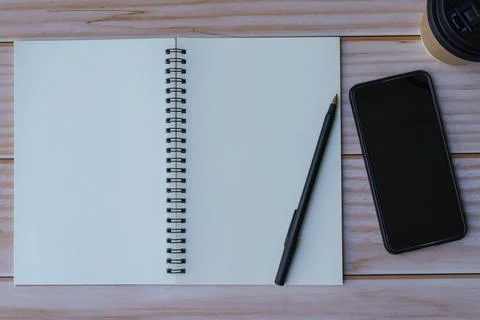 Note book on wooden table. Space for text. Flat lay and top view Stock Photos