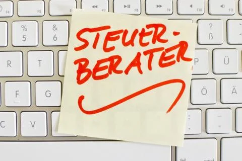 Note on computer keyboard tax services Stock Photos