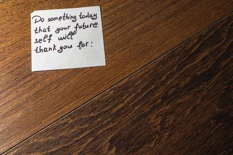 Note encouraging future self-improvement on wooden table surface Stock Photos